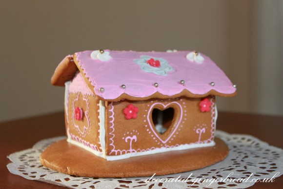 Pink gingerbread house with flowers