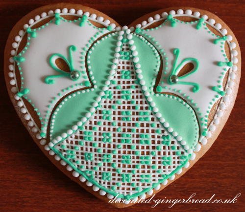 Beautifully decorated gingerbread heart with royal icing