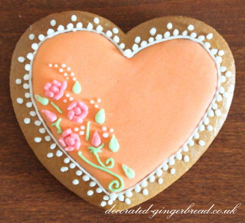 Decorated Gingerbread heart with orange sugar glazing and flower ornament